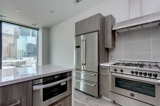 a kitchen with stainless steel appliances a refrigerator and a sink