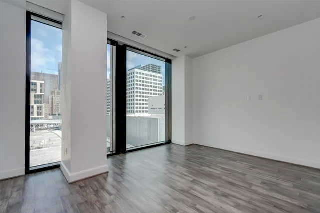 a view of a room with wooden floor and a window