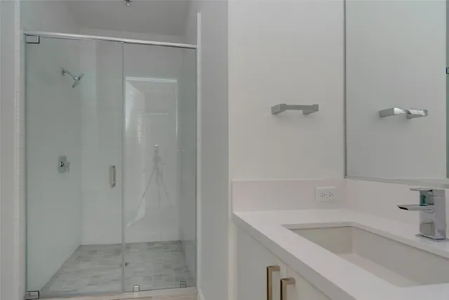 a bathroom with a sink and shower