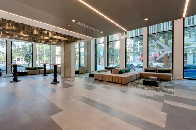 a large bedroom with large mirror and furniture