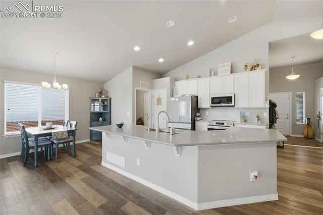a large kitchen with stainless steel appliances lots of counter space and breakfast area