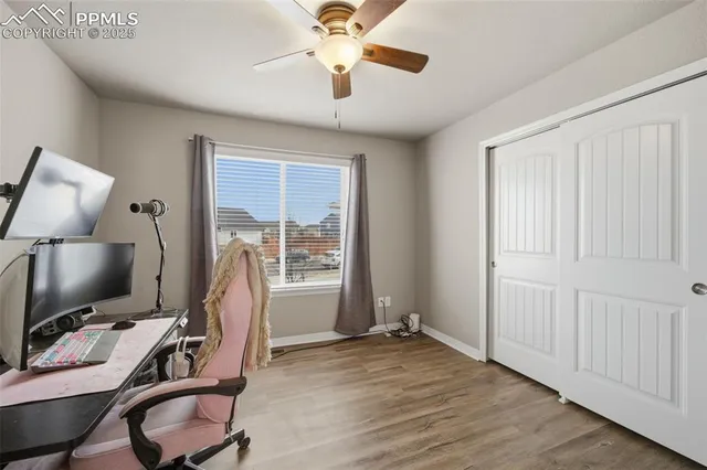 a view of a workspace with furniture and a window