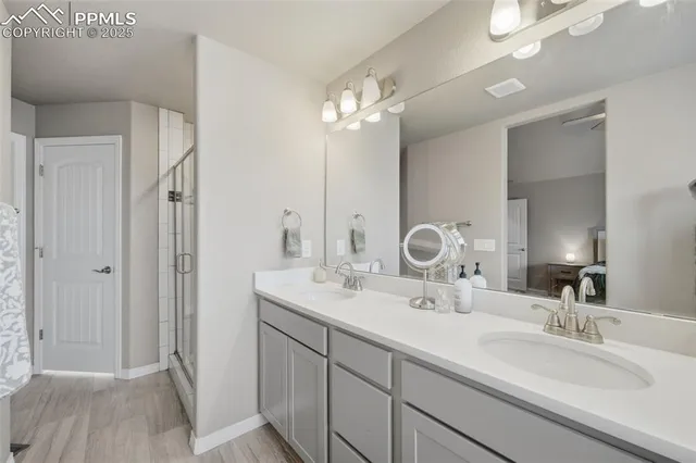 a bathroom with a double vanity sink and a mirror
