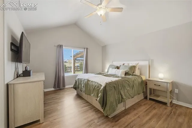 a spacious bedroom with a bed and a flat screen tv