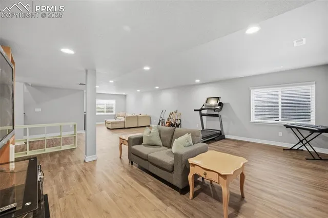 a living room with furniture and a wooden floor