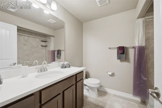 a bathroom with a sink mirror vanity and toilet