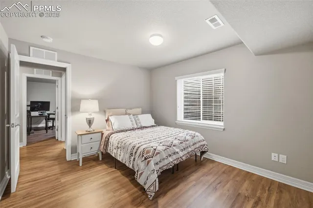 a bedroom with a bed and a table