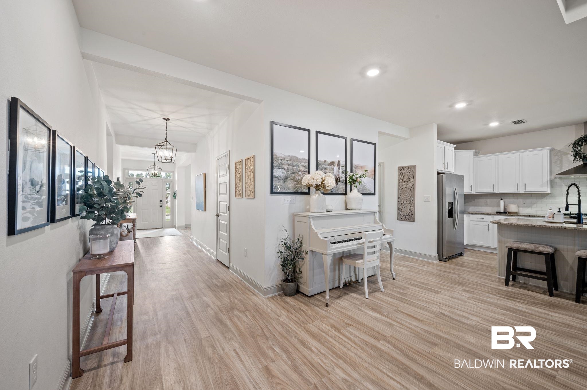 10169 Dunleith Loop Daphne, AL 36526 - Photo 20 of 40 Hallway featuring light wood-type flooring, a chandelier, and recessed lighting