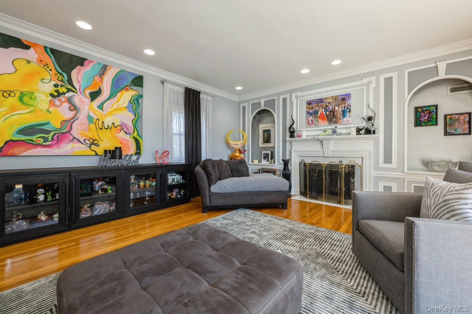 123 Barrett Road Lawrence, NY 11559 - Photo 5 of 32 a living room with furniture a flat screen tv and a floor to ceiling window