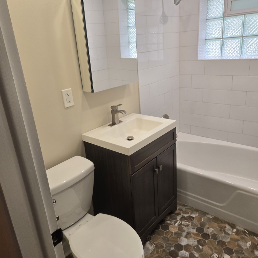 1817 West Touhy Avenue, Unit 2E Park Ridge, IL 60068 - Photo 11 of 19 a bathroom with a sink a toilet and shower