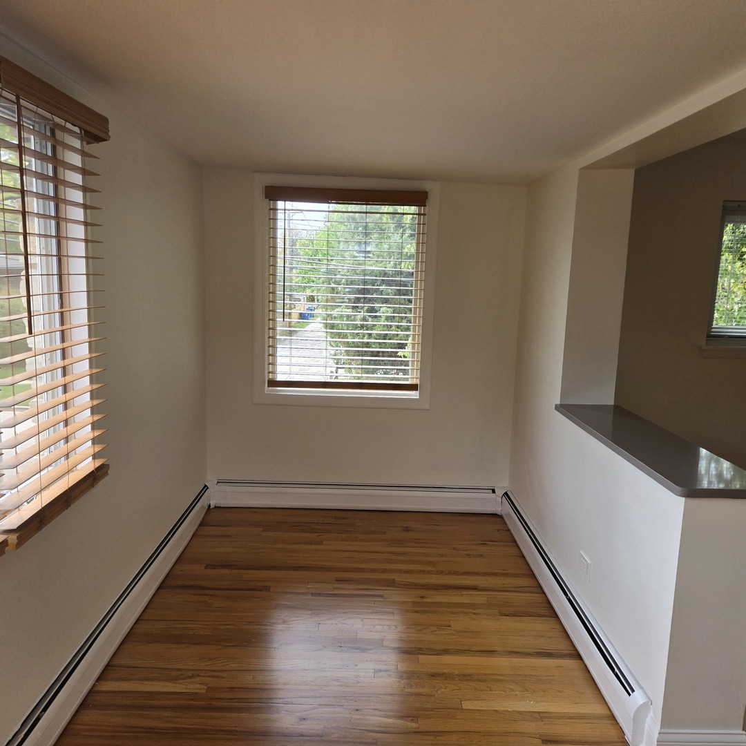1817 West Touhy Avenue, Unit 2E Park Ridge, IL 60068 - Photo 17 of 19 a view of a room with wooden floor and window