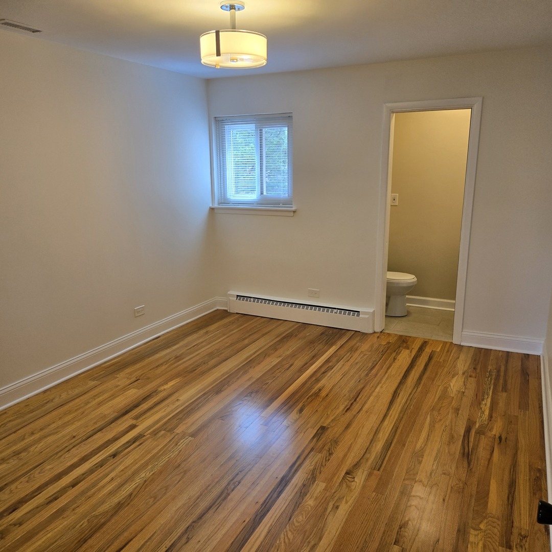 1817 West Touhy Avenue, Unit 2E Park Ridge, IL 60068 - Photo 7 of 19 a view of empty room with wooden floor
