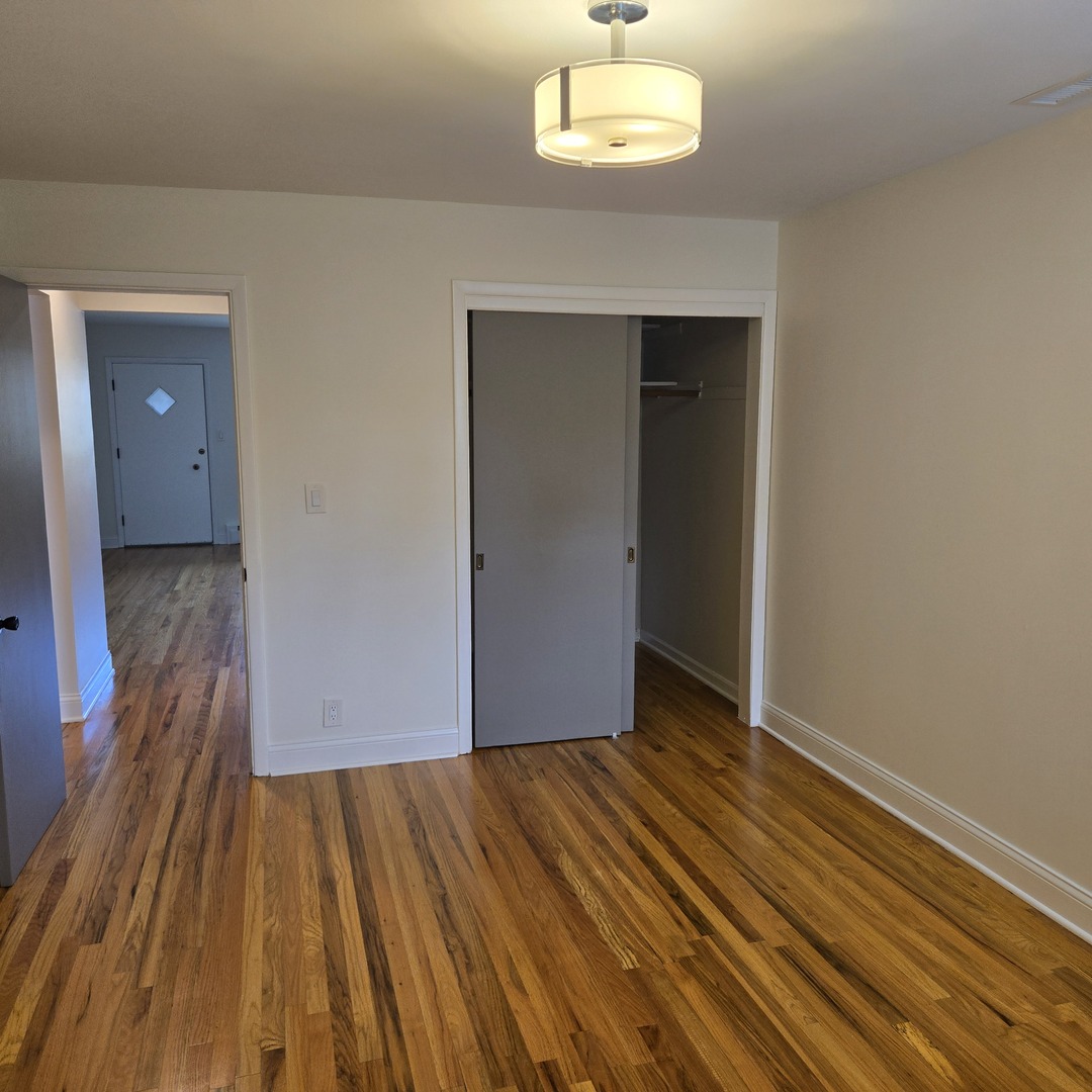 1817 West Touhy Avenue, Unit 2E Park Ridge, IL 60068 - Photo 9 of 19 wooden floor in an empty room
