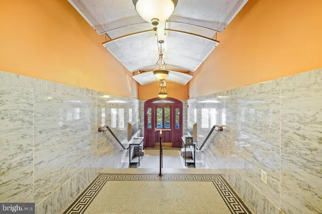 a view of hall way with furniture