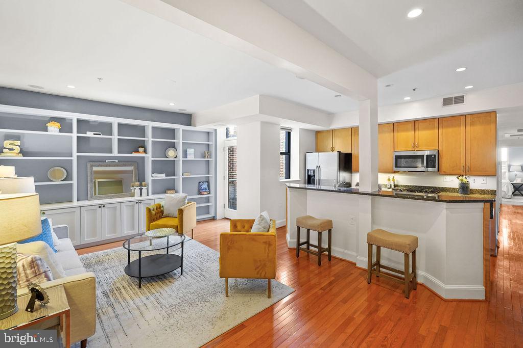 1419 Clifton Street Northwest, Unit 304 Washington, DC 20009 - Photo 3 of 22 a living room with furniture and floor to ceiling windows