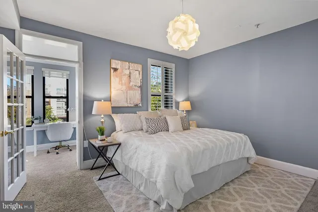 a bedroom with a bed and a chandelier