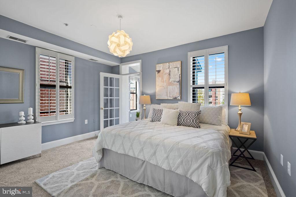 1419 Clifton Street Northwest, Unit 304 Washington, DC 20009 - Photo 7 of 22 a bedroom with a bed and a chandelier