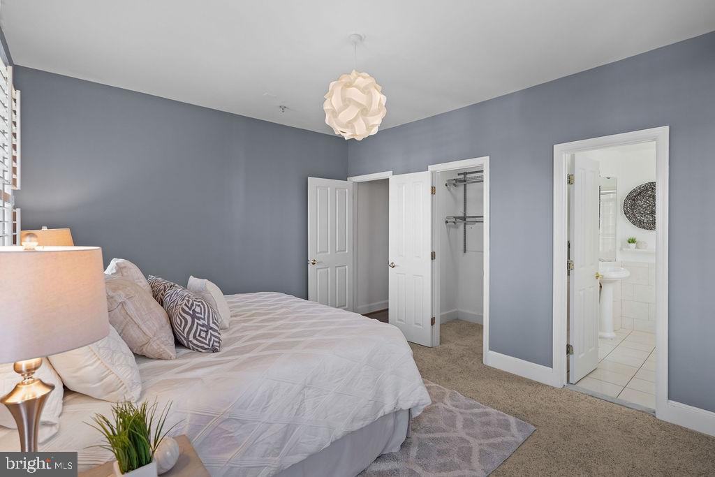 1419 Clifton Street Northwest, Unit 304 Washington, DC 20009 - Photo 8 of 22 a bedroom with a bed and a chandelier