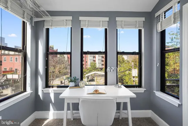 a room with kitchen island a large window in it