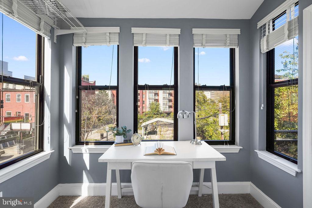 1419 Clifton Street Northwest, Unit 304 Washington, DC 20009 - Photo 9 of 22 a room with kitchen island a large window in it
