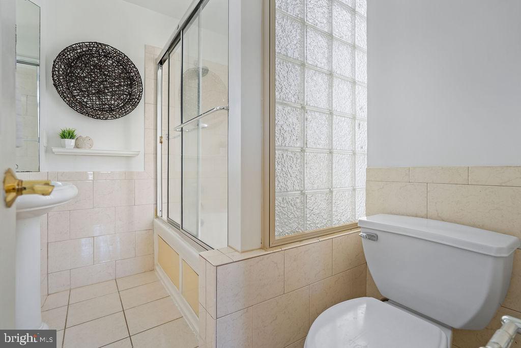 1419 Clifton Street Northwest, Unit 304 Washington, DC 20009 - Photo 10 of 22 a bathroom with a toilet and a shower