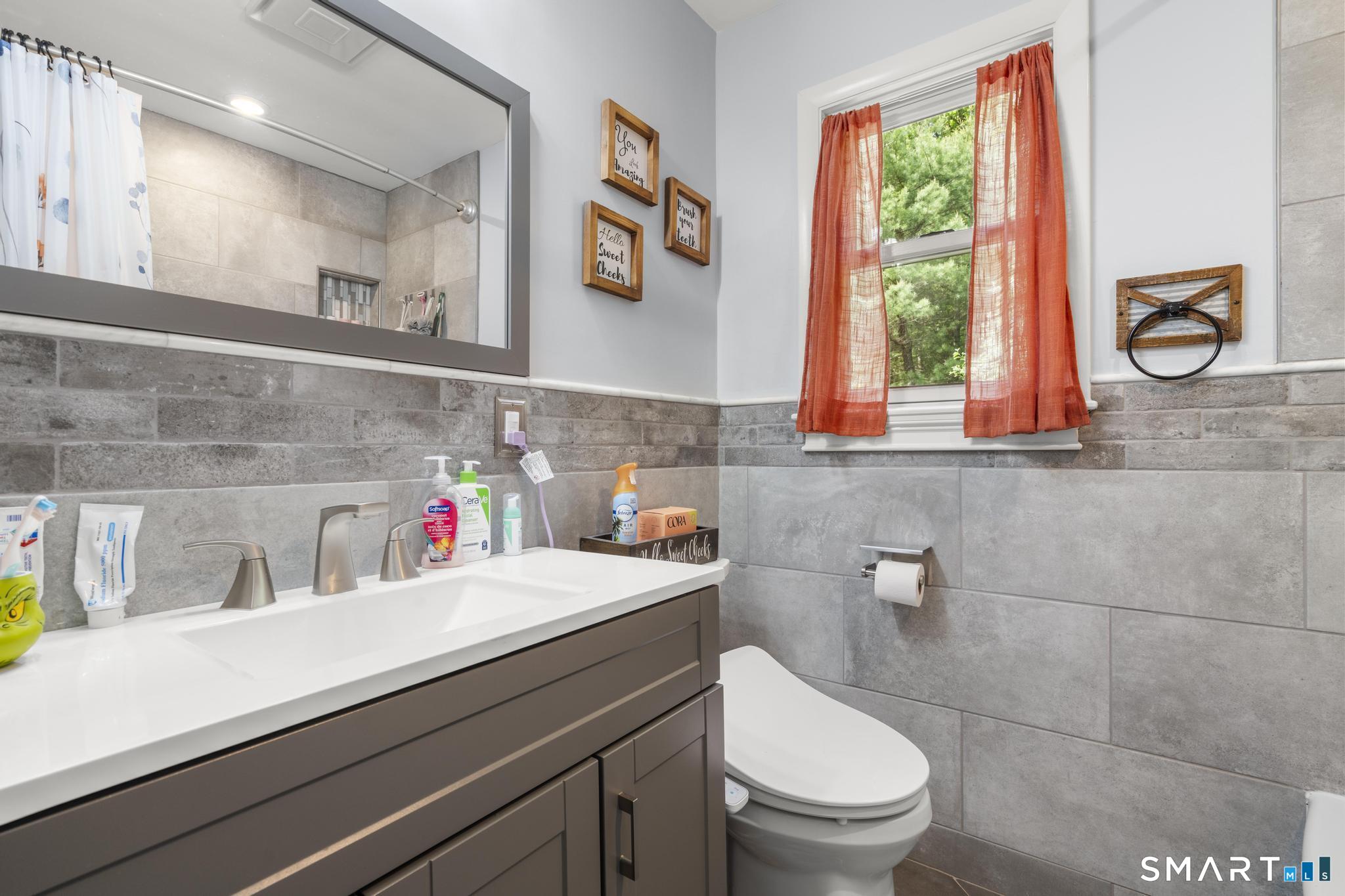 13 Christy Hill Road Ledyard, CT 06335 - Photo 16 of 38 a bathroom with a toilet a sink and a window