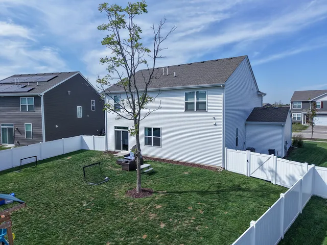 a front view of house with a garden