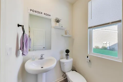 a bed sitting in a spacious bedroom next to a window and a larger closet