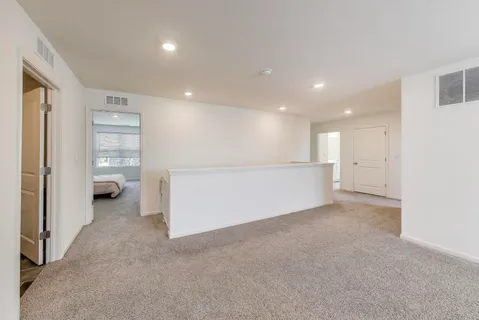 a spacious bedroom with a bed and a window