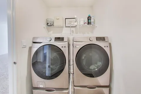 an aerial view of residential houses with outdoor space and parking