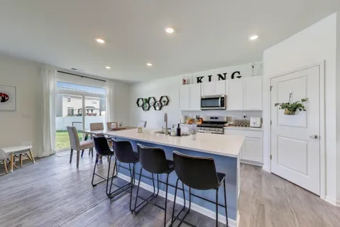 a kitchen with stove a sink and a microwave