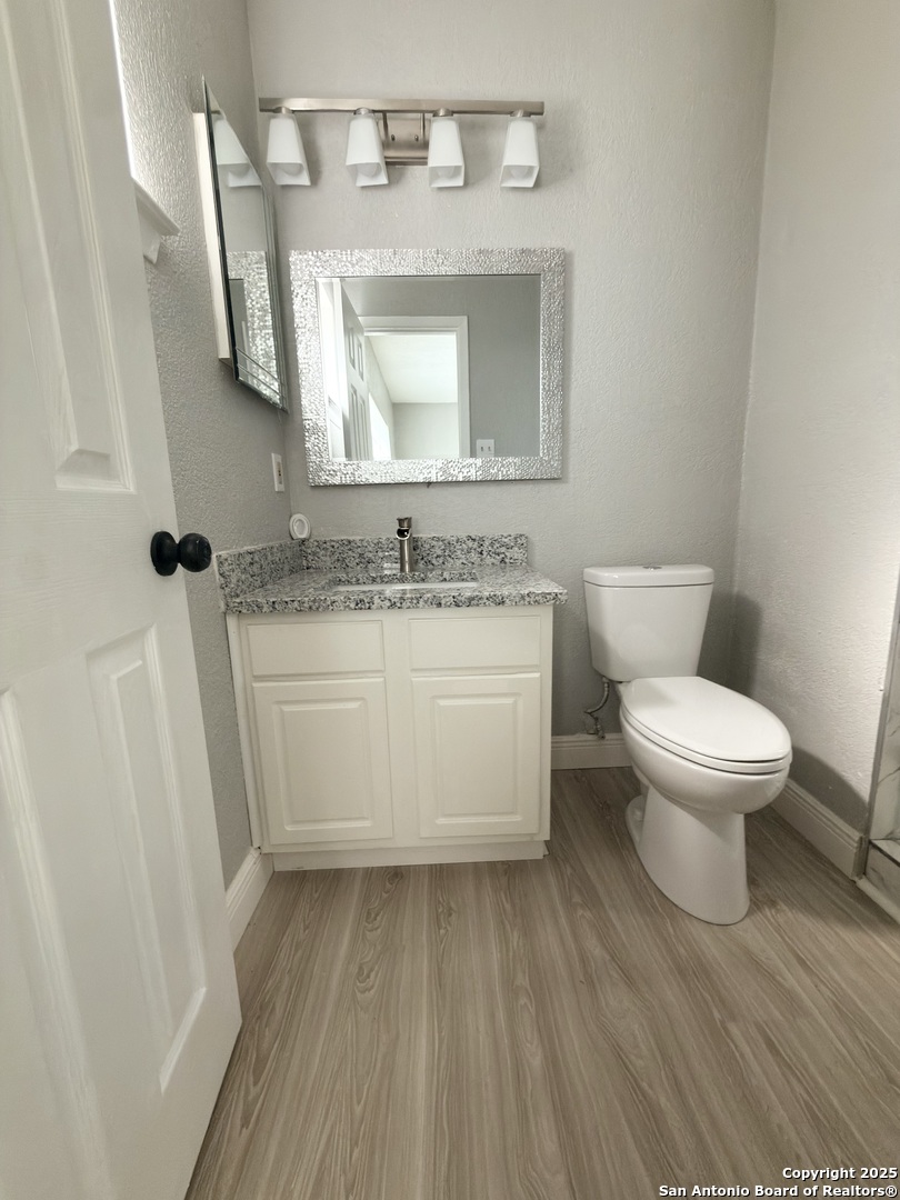 14519 Ridge Meadow Drive San Antonio, TX 78233 - Photo 13 of 25 a white toilet sitting next to a bathroom sink