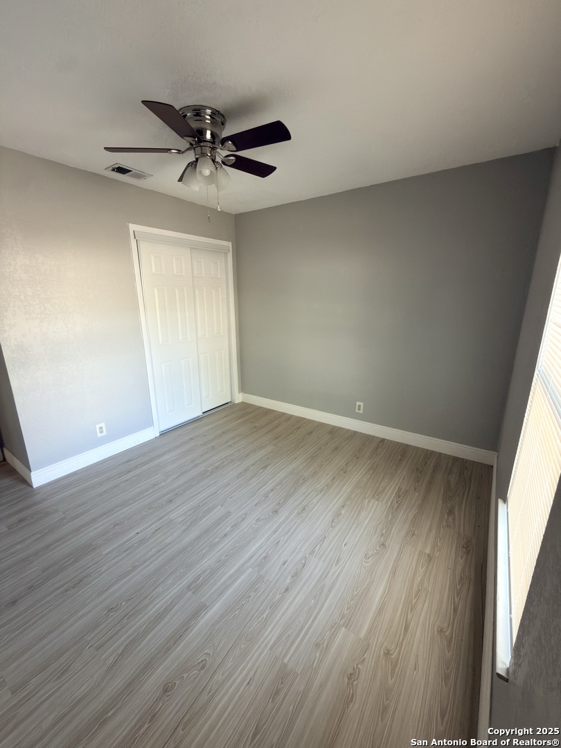 14519 Ridge Meadow Drive San Antonio, TX 78233 - Photo 15 of 25 wooden floor in an empty room with a window