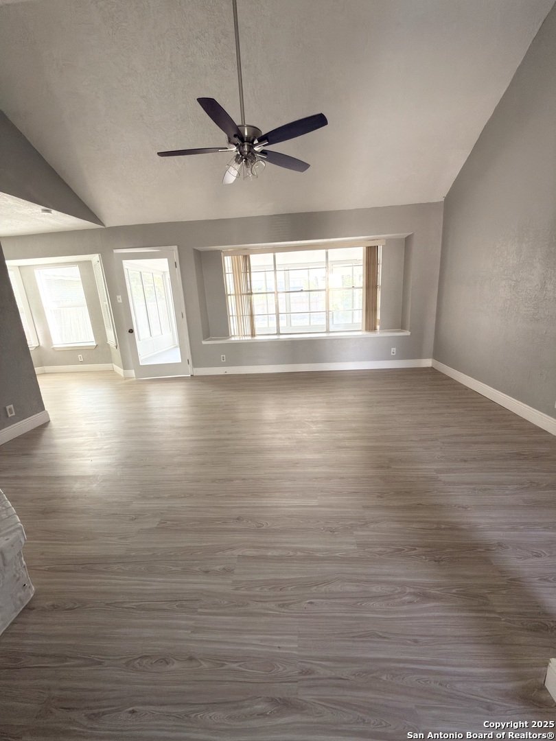 14519 Ridge Meadow Drive San Antonio, TX 78233 - Photo 4 of 25 a view of empty room with wooden floor and fan