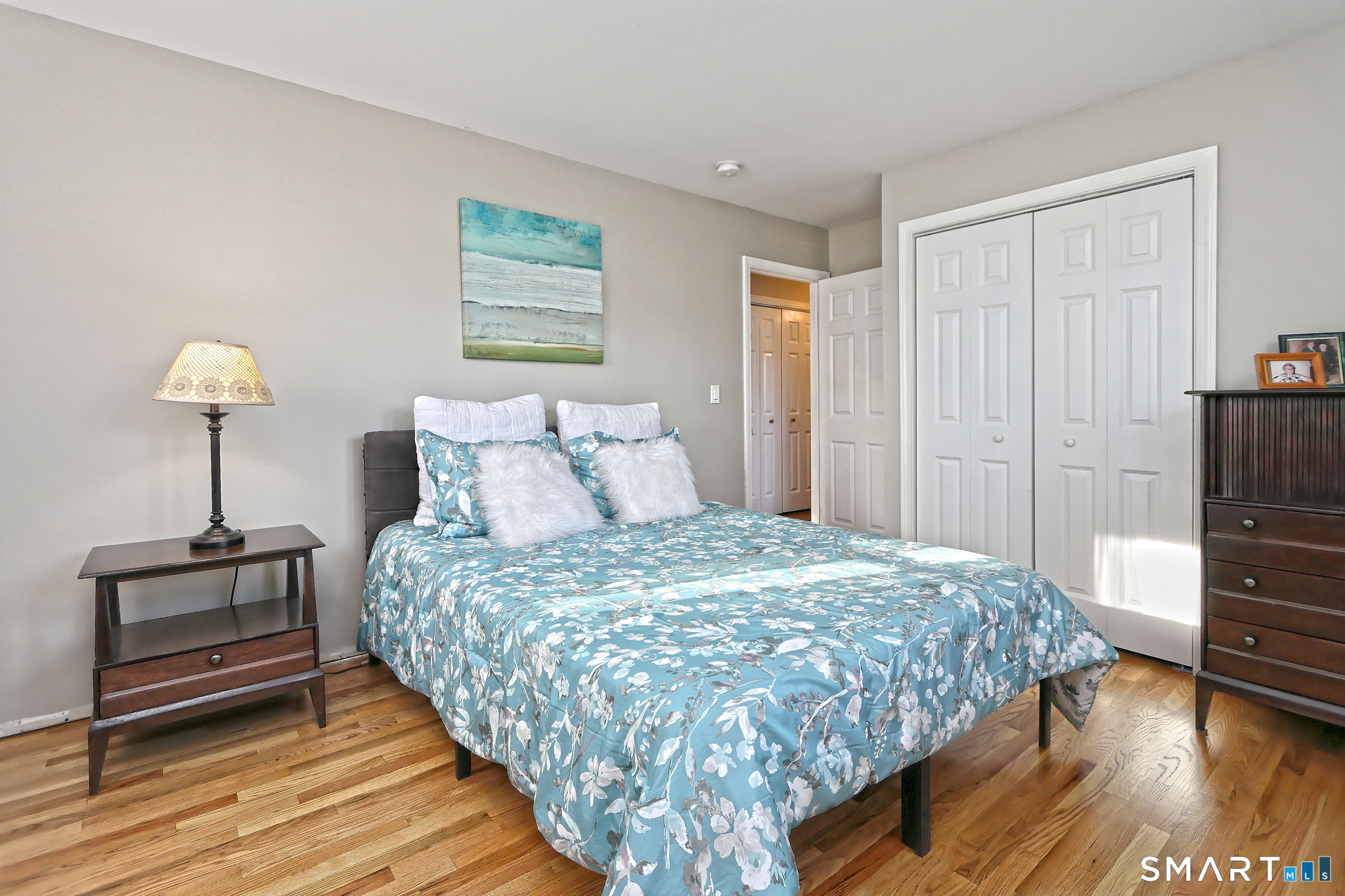 53 Pheasant Road West Haven, CT 06516 - Photo 20 of 39 a bedroom with a bed and a chandelier