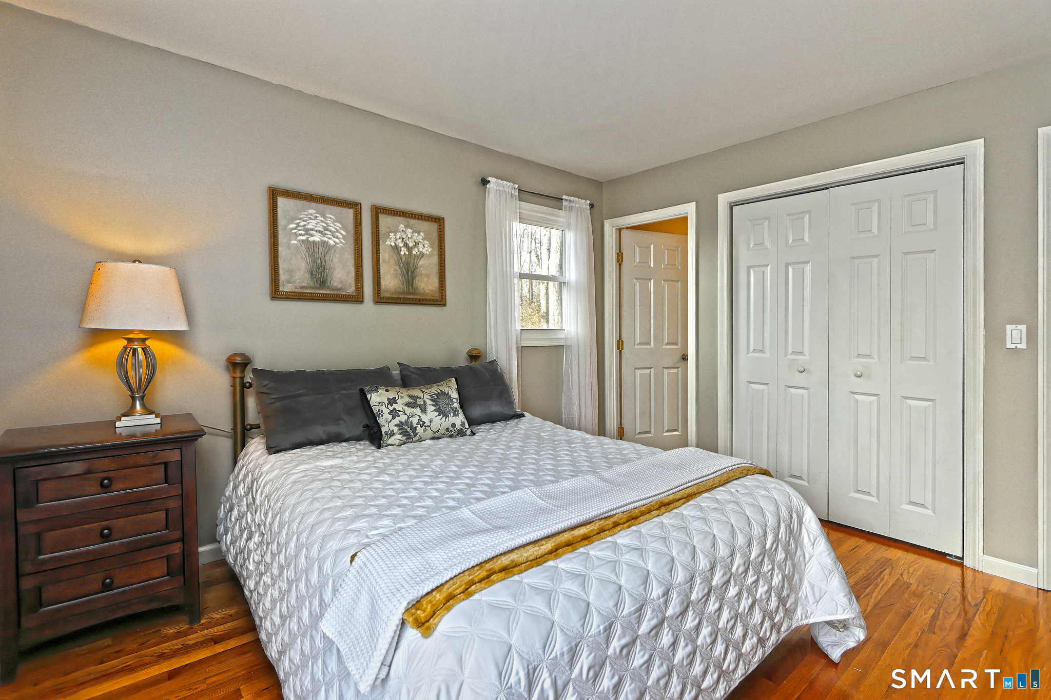 53 Pheasant Road West Haven, CT 06516 - Photo 24 of 39 a bedroom with a bed and a lamp on dresser