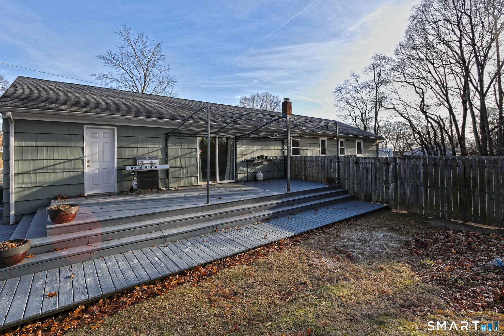 53 Pheasant Road West Haven, CT 06516 - Photo 35 of 39 a view of a house with a small yard and wooden floor and fence