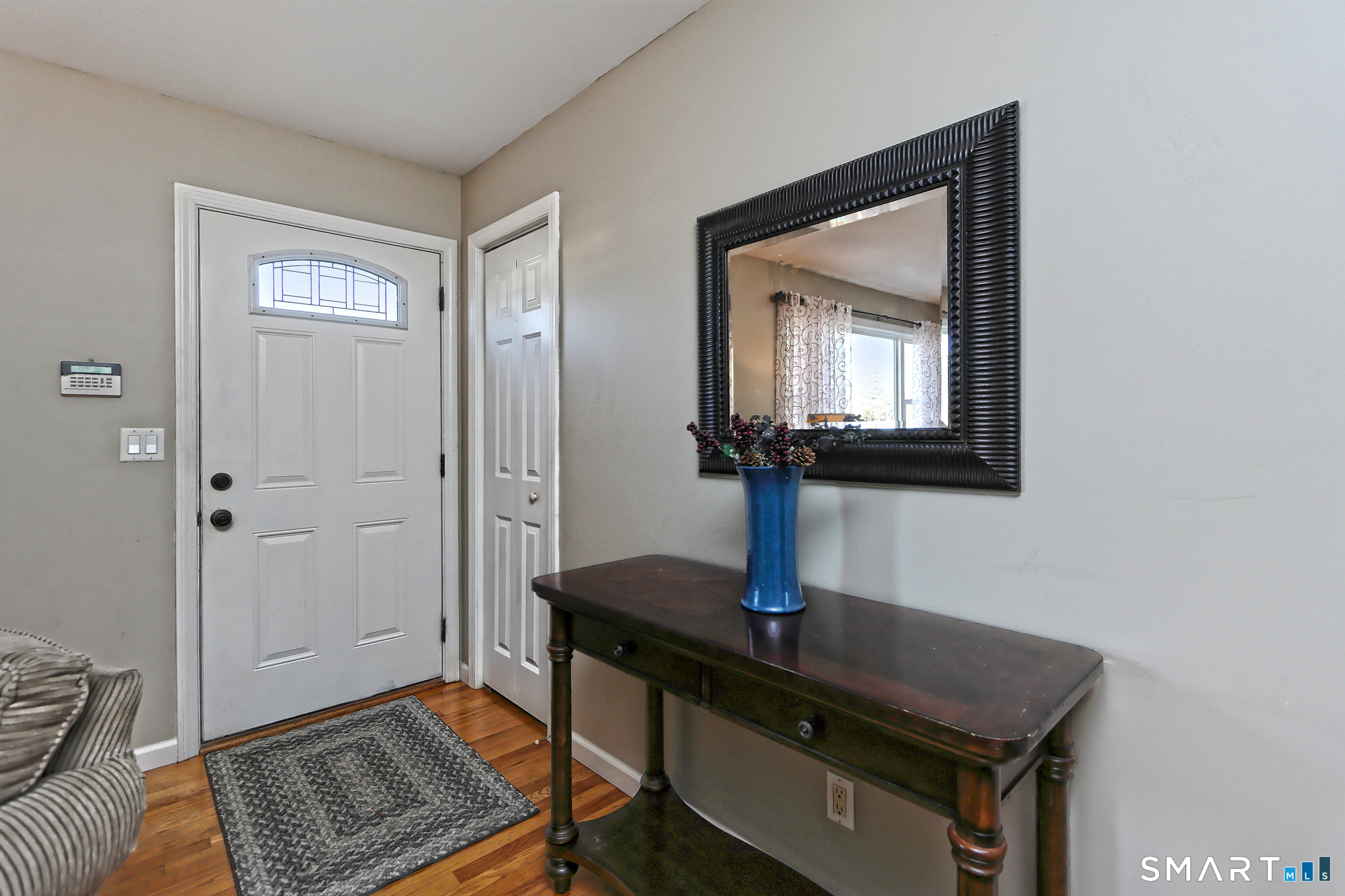 53 Pheasant Road West Haven, CT 06516 - Photo 4 of 39 a view of a livingroom with a potted plant and wooden floor