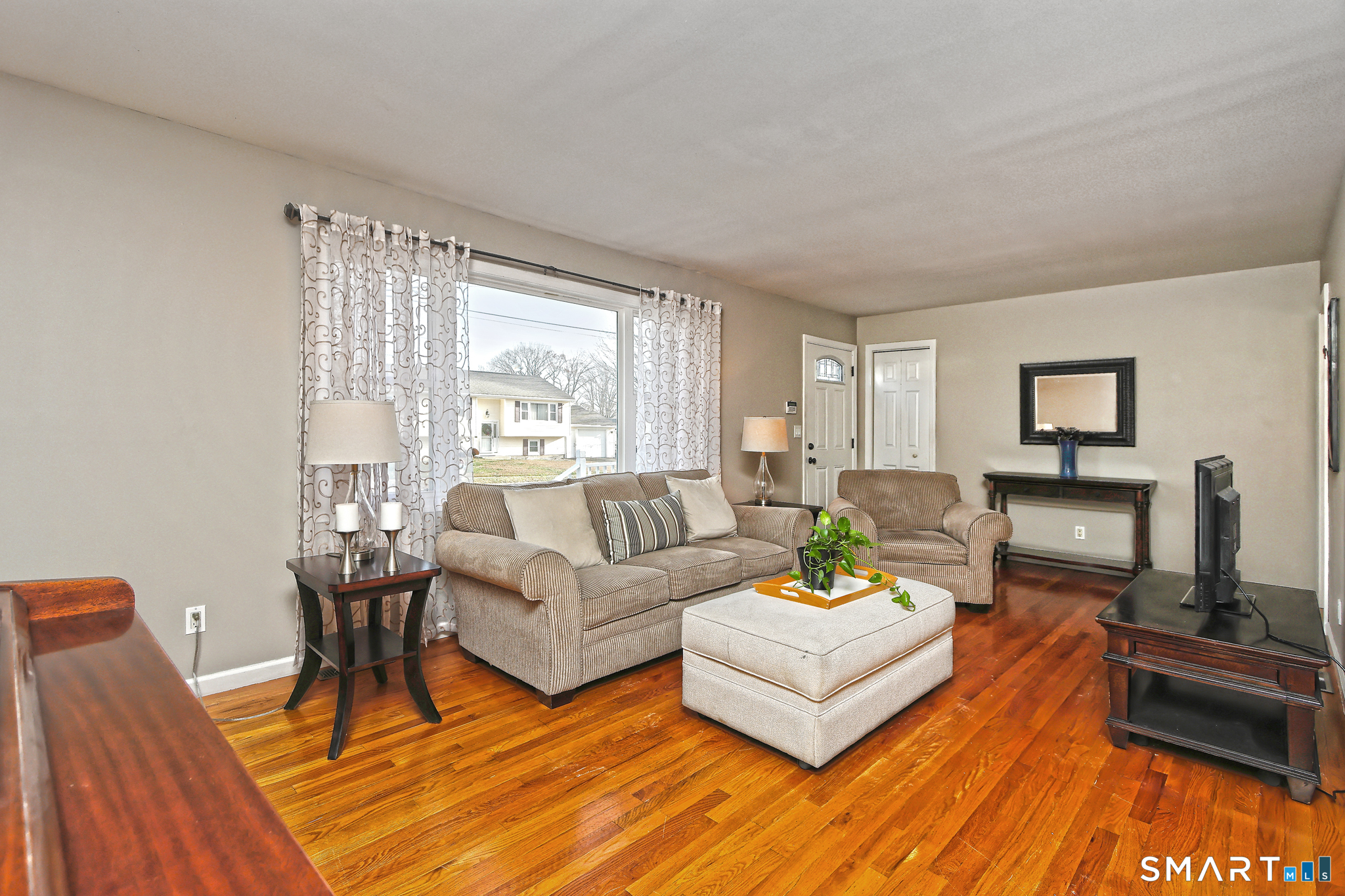 53 Pheasant Road West Haven, CT 06516 - Photo 6 of 39 a living room with furniture and a flat screen tv