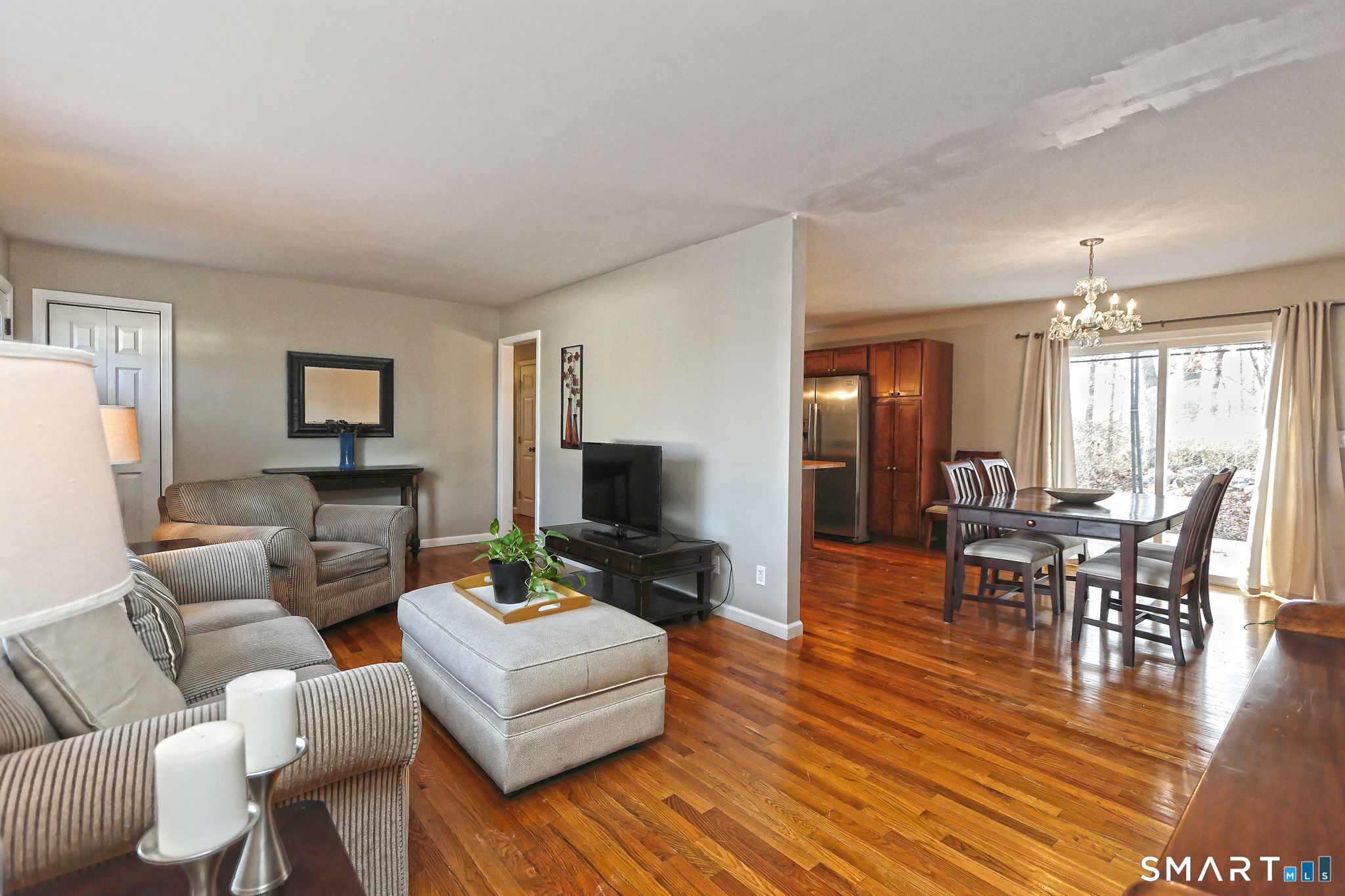 53 Pheasant Road West Haven, CT 06516 - Photo 7 of 39 a living room with furniture a dining table and a fireplace