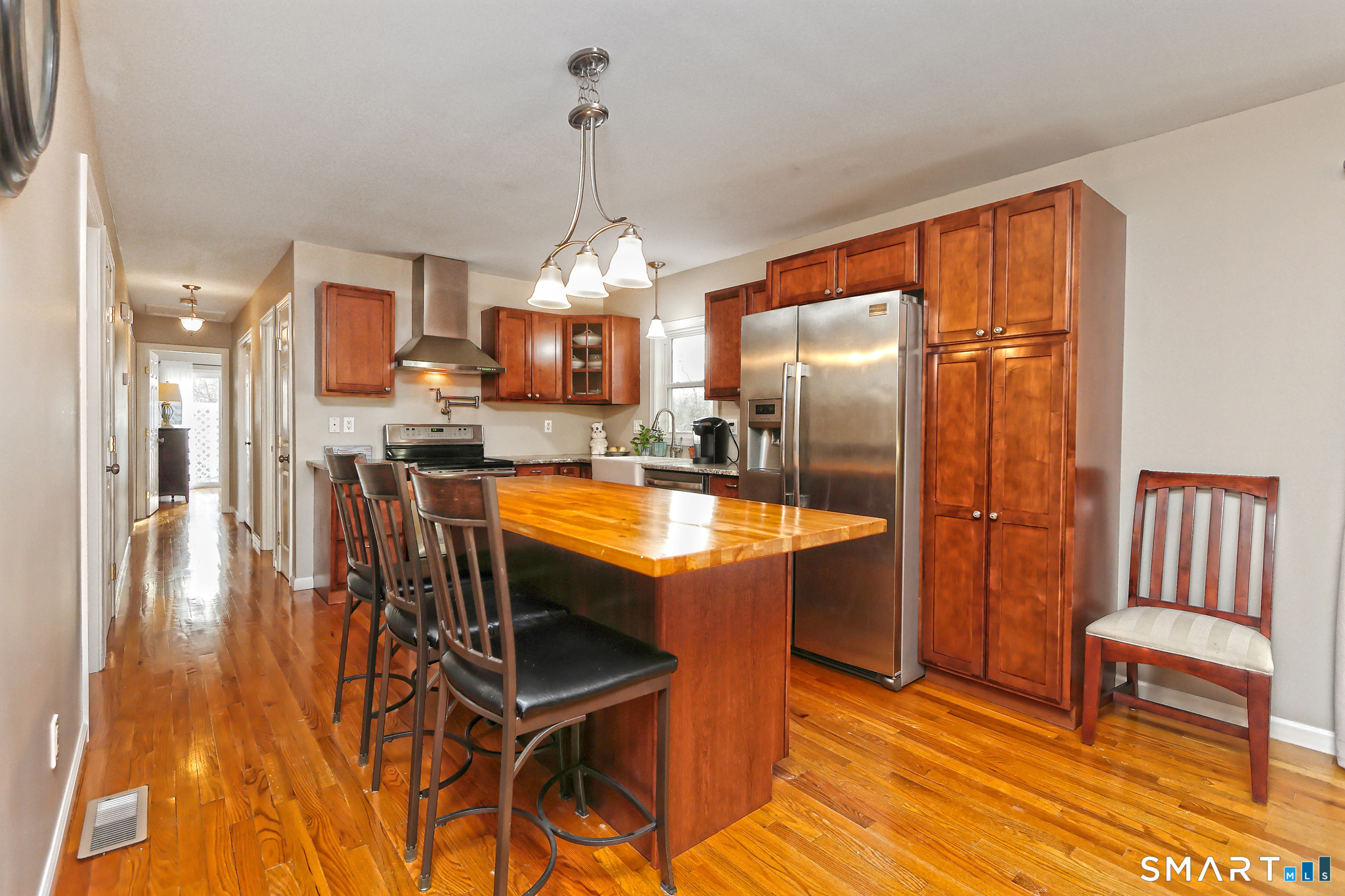 53 Pheasant Road West Haven, CT 06516 - Photo 10 of 39 a room with stainless steel appliances kitchen island granite countertop furniture and a wooden floor