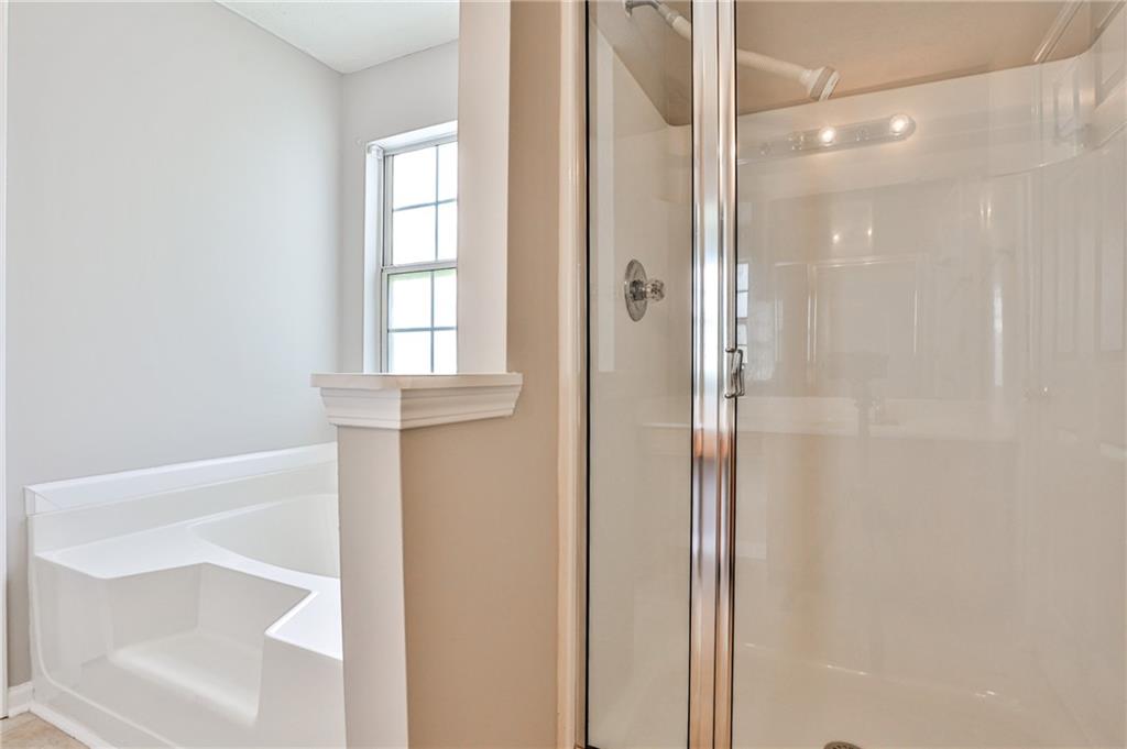 1505 Heatherton Road Dacula, GA 30019 - Photo 17 of 33 a bathroom with a glass shower door