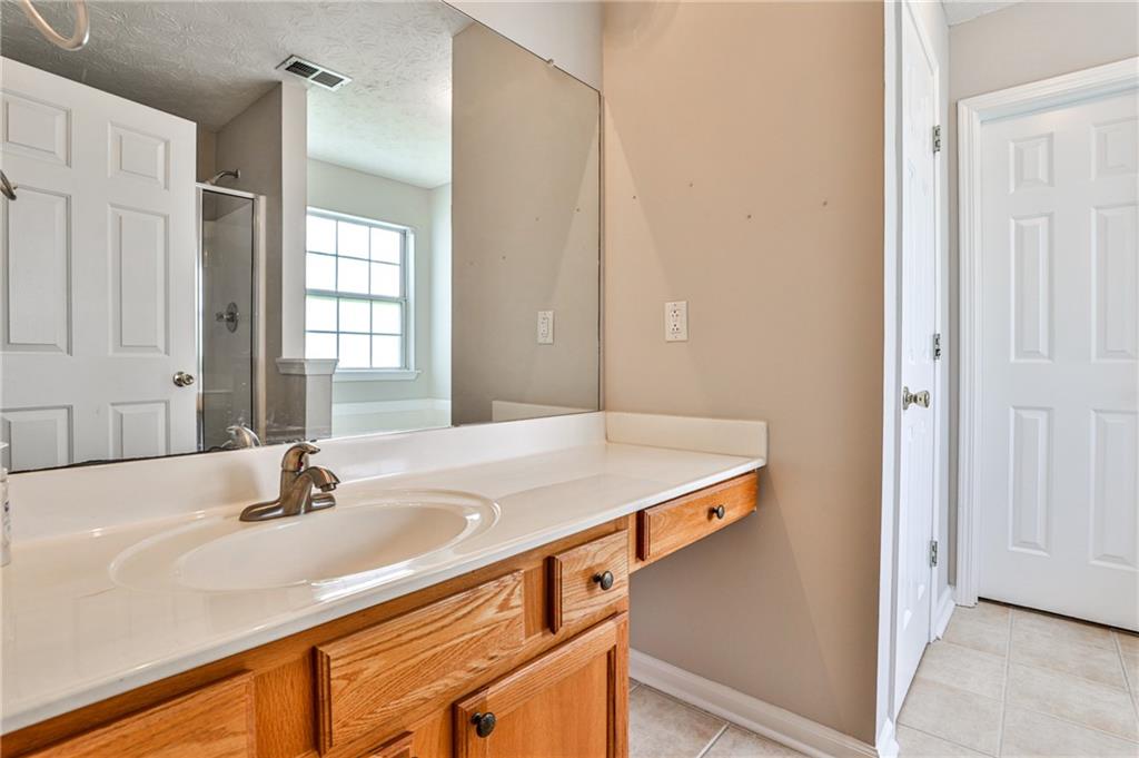 1505 Heatherton Road Dacula, GA 30019 - Photo 18 of 33 a bathroom with a sink and a mirror