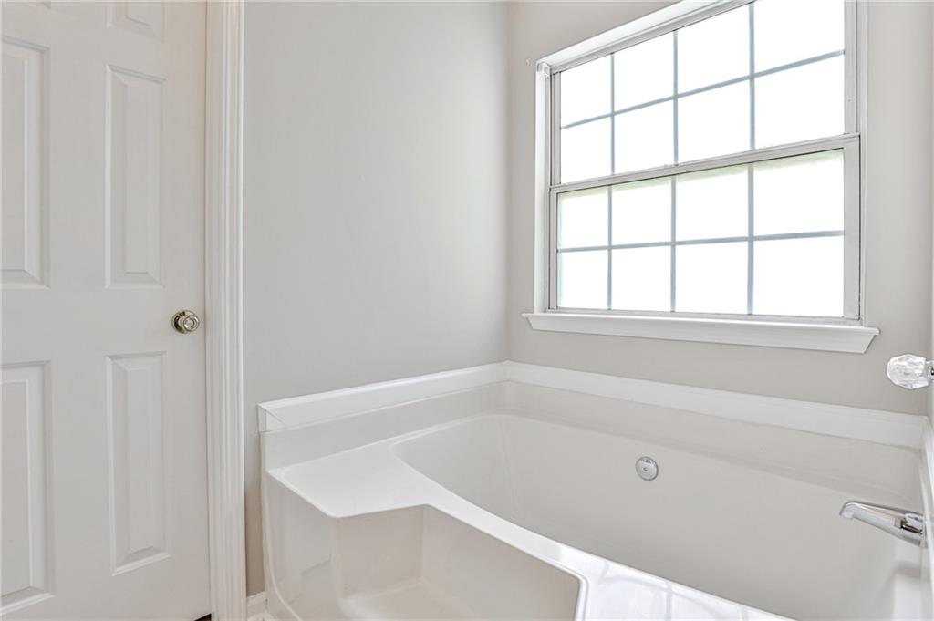 1505 Heatherton Road Dacula, GA 30019 - Photo 19 of 33 a white bath tub sitting next to a window