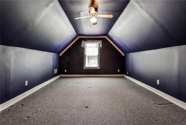 a view of an empty room and a ceiling fan