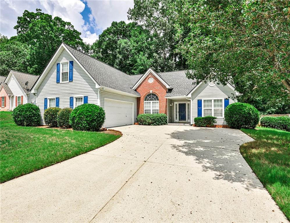 1505 Heatherton Road Dacula, GA 30019 - Photo 2 of 33 a front view of a house with a yard and garage