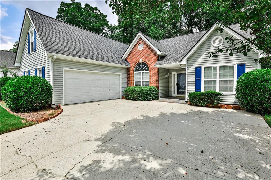 1505 Heatherton Road Dacula, GA 30019 - Photo 3 of 33 a front view of a house with a yard and garage