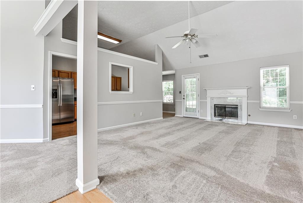 1505 Heatherton Road Dacula, GA 30019 - Photo 4 of 33 an empty room with windows and fireplace