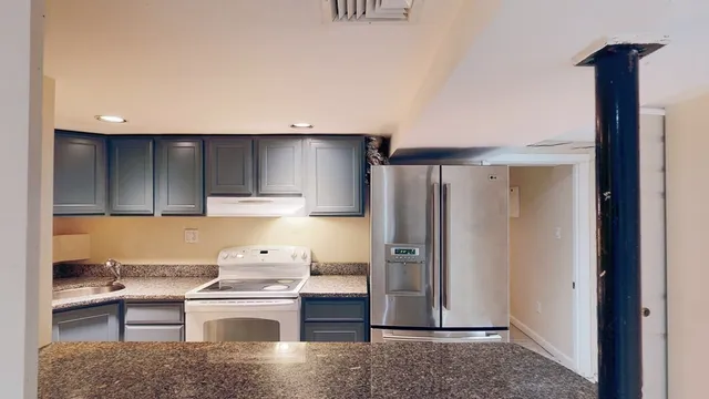 a kitchen with a refrigerator and a sink