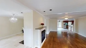 a hallway with wooden floor and staircase